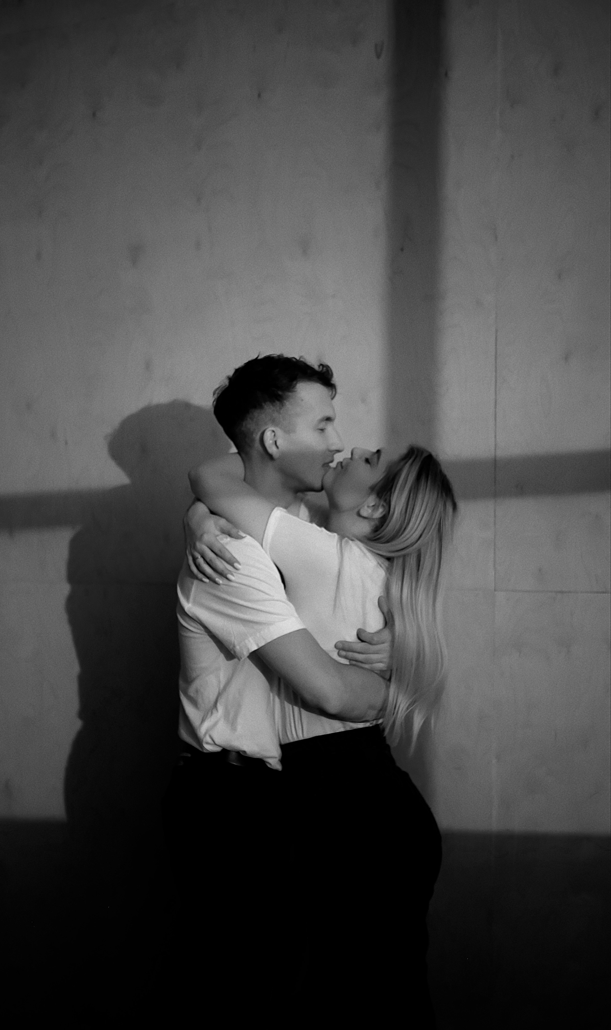 a man and a woman embracing in a black and white photo