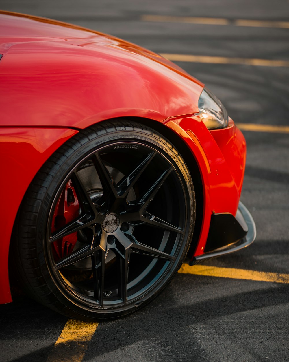 a red sports car parked in a parking lot