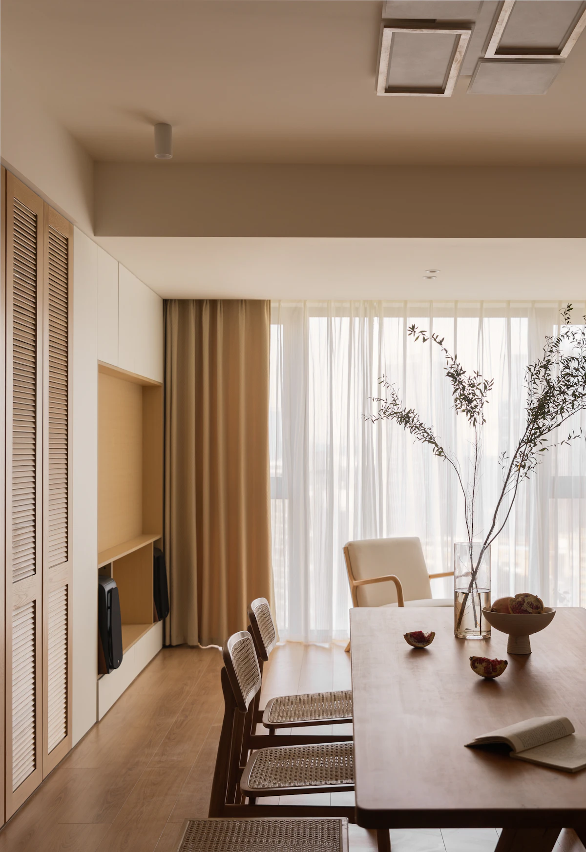 Floor-length linen curtains and timber shutters in soft daylight