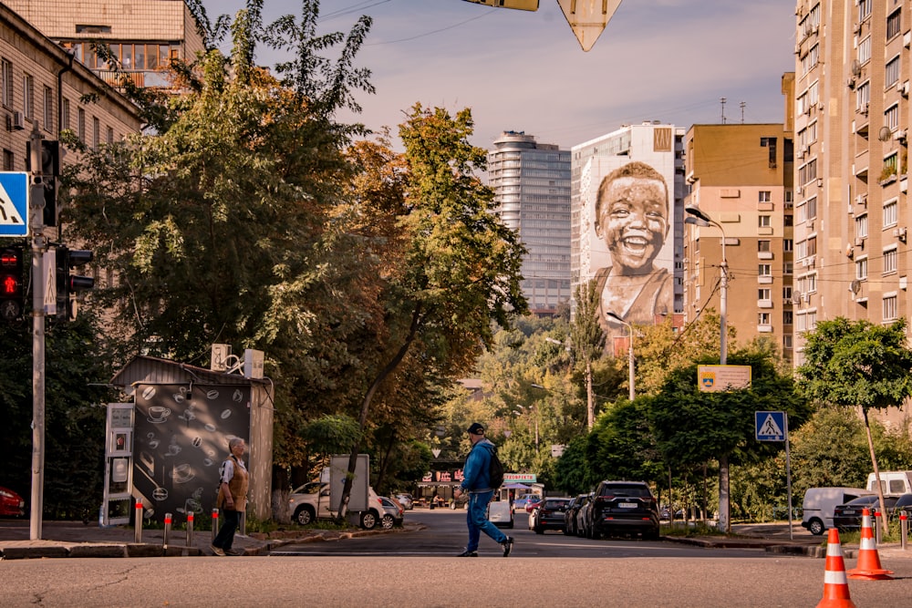 a man walking down a street next to tall buildings