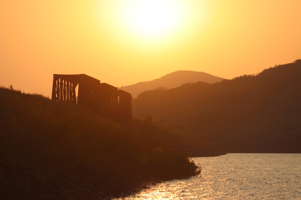 the sun is setting over a body of water