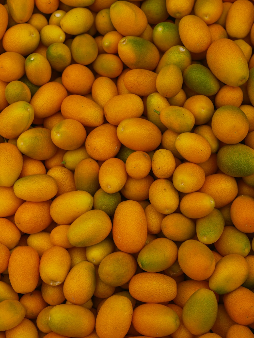 a pile of oranges and limes sitting next to each other