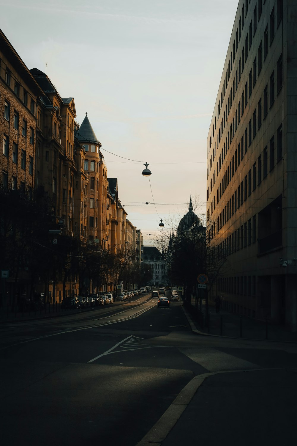 a city street with buildings and a cable car