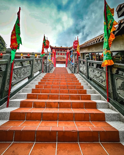 A scenic view of Mandar Parvat with pilgrims climbing the steps during sunset.