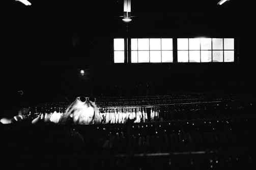 A side profile of a person interacting with a virtual wardrobe interface in low light.