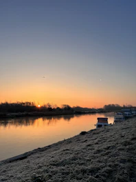 Volunteer monitoring water quality along the Tardoire river at sunrise.
