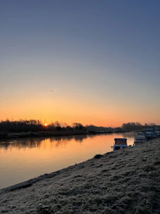 Volunteer monitoring water quality along the Tardoire river at sunrise.