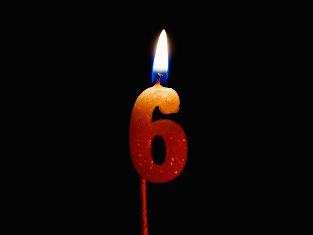 a birthday candle with the number six on it