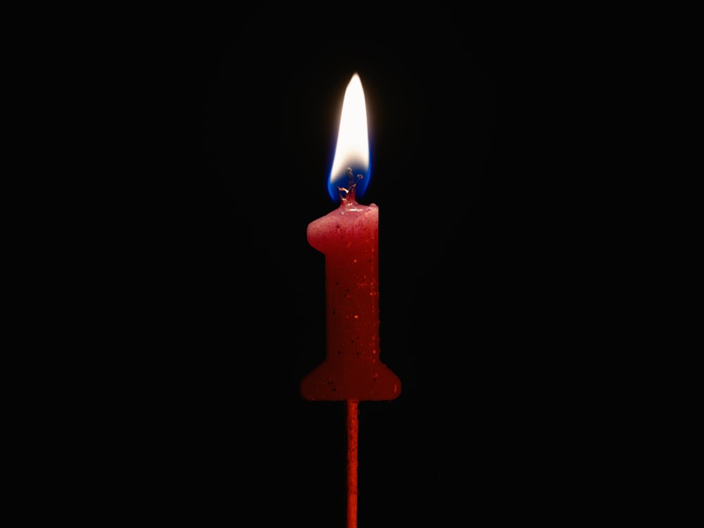 a red candle with a lit candle inside of it