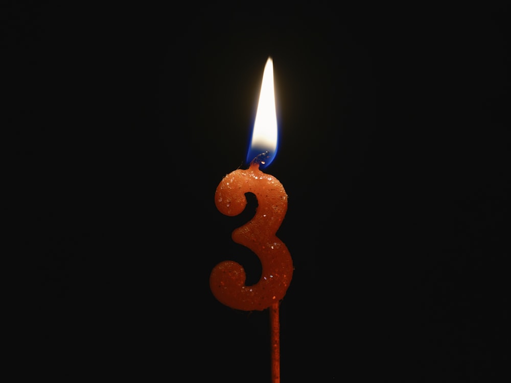a birthday candle with a candle number three on it
