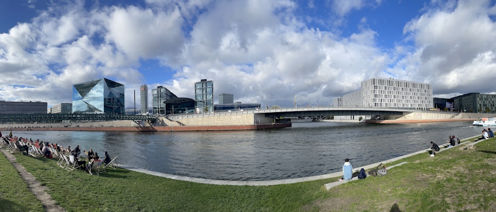 a group of people riding horses next to a body of water