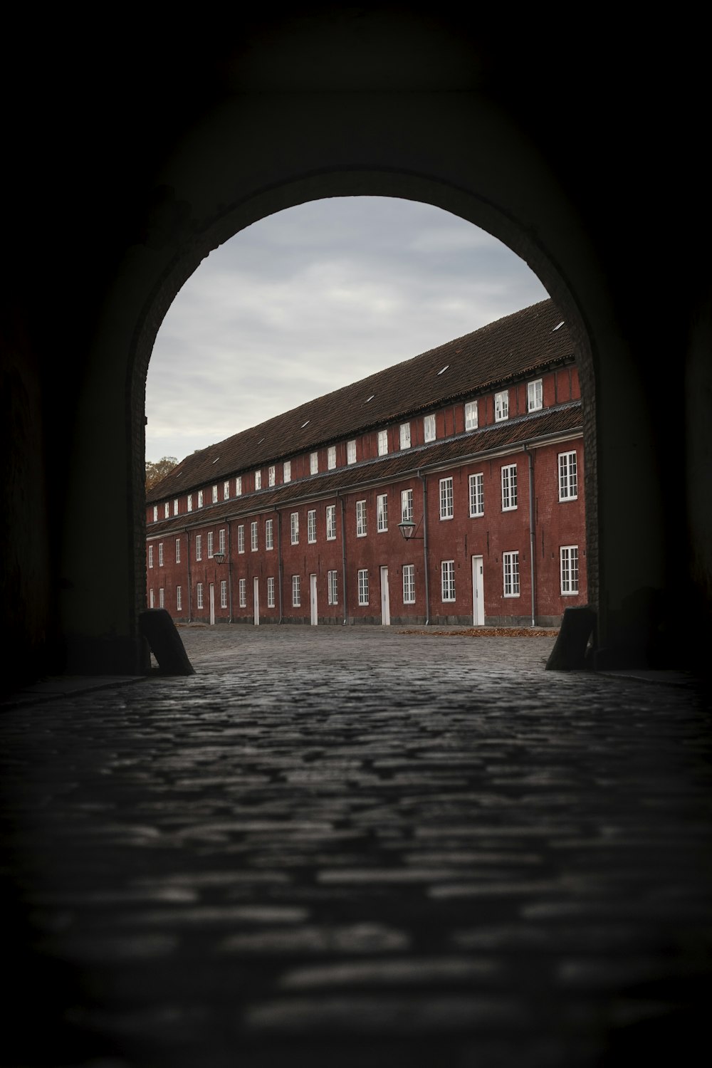 a large brick building with an arched doorway