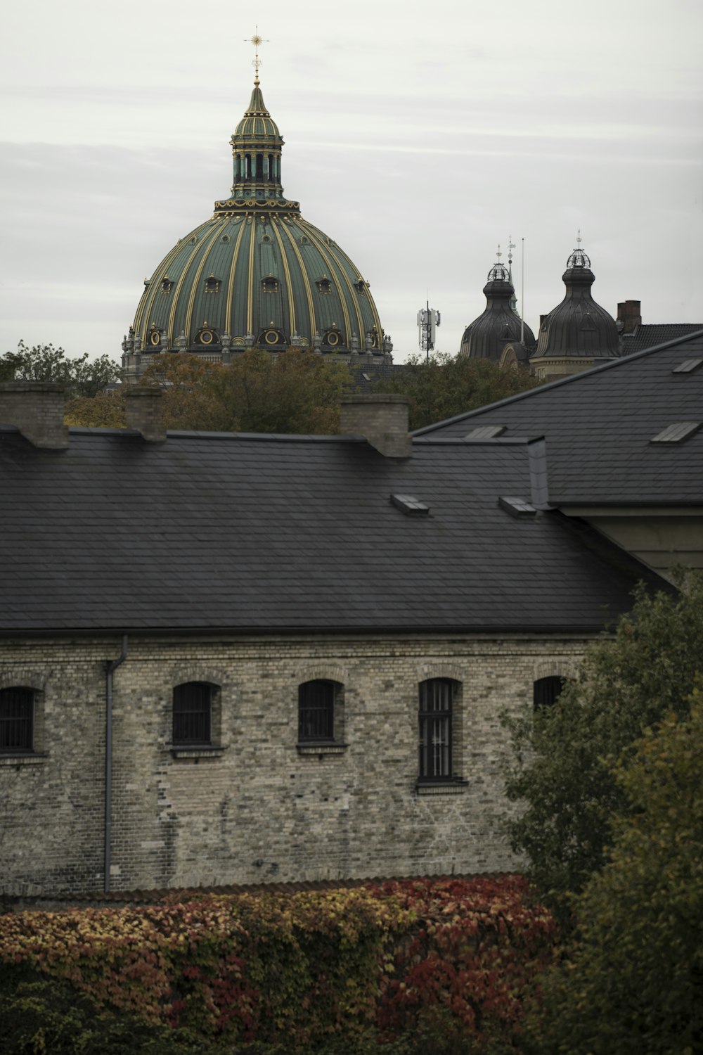 a view of a building with a dome in the background