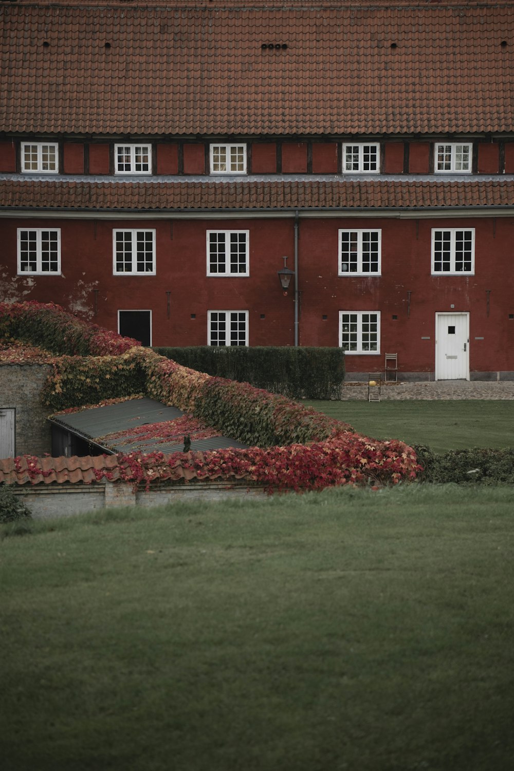 a red building with a white door and windows