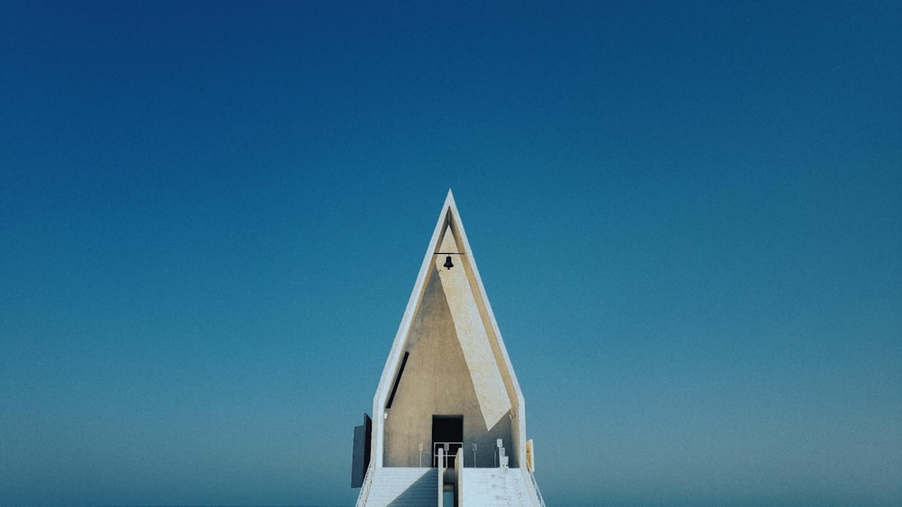 a very tall building sitting on top of a beach