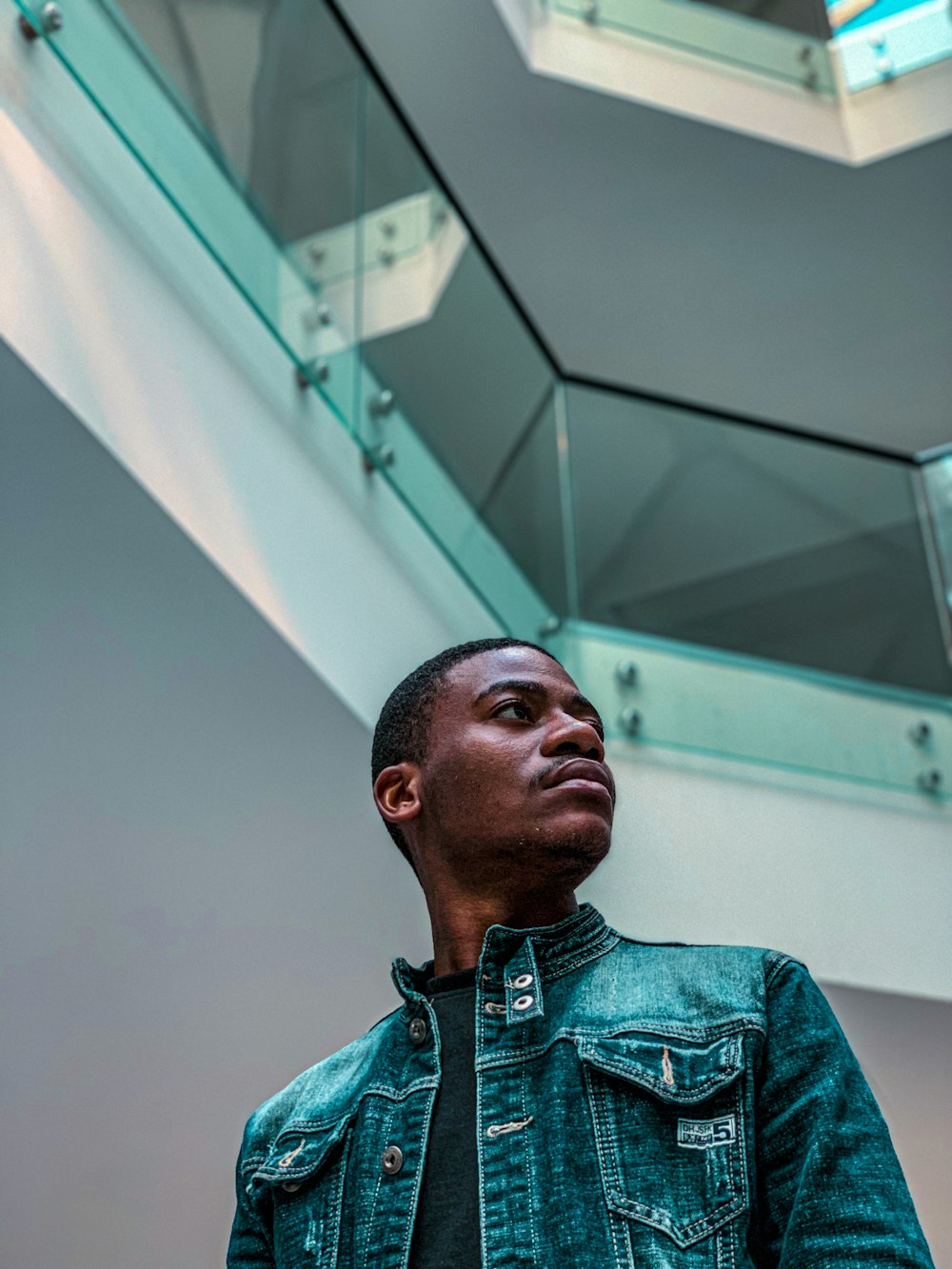 a man standing in front of a glass staircase