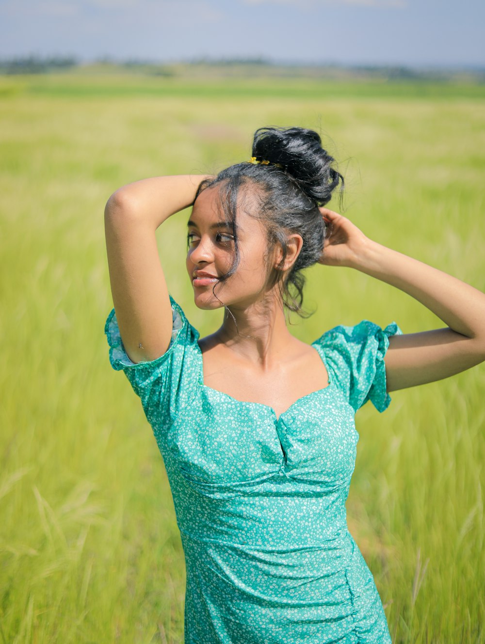 a woman standing in a field of tall grass