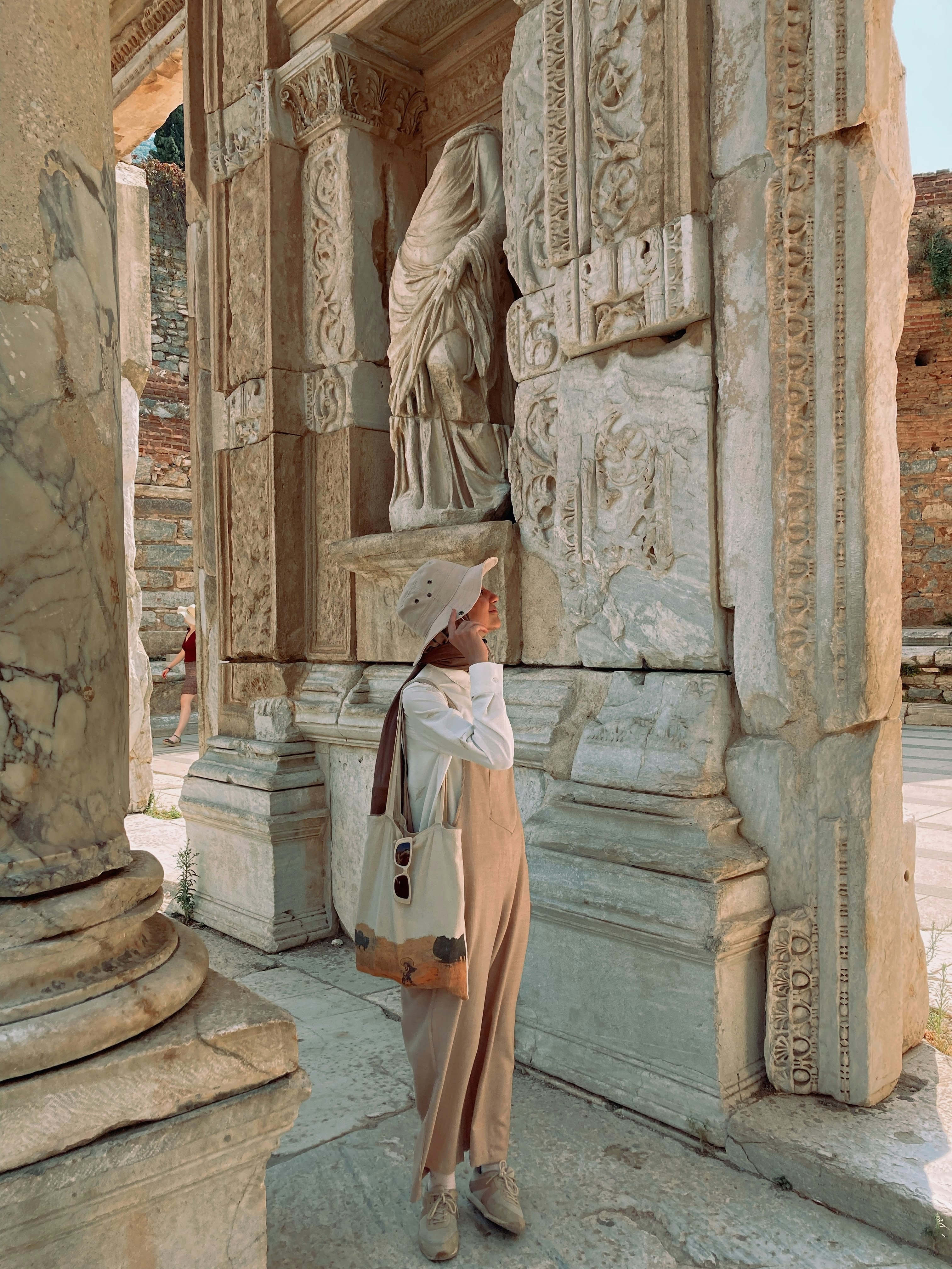 a woman is standing in front of a statue