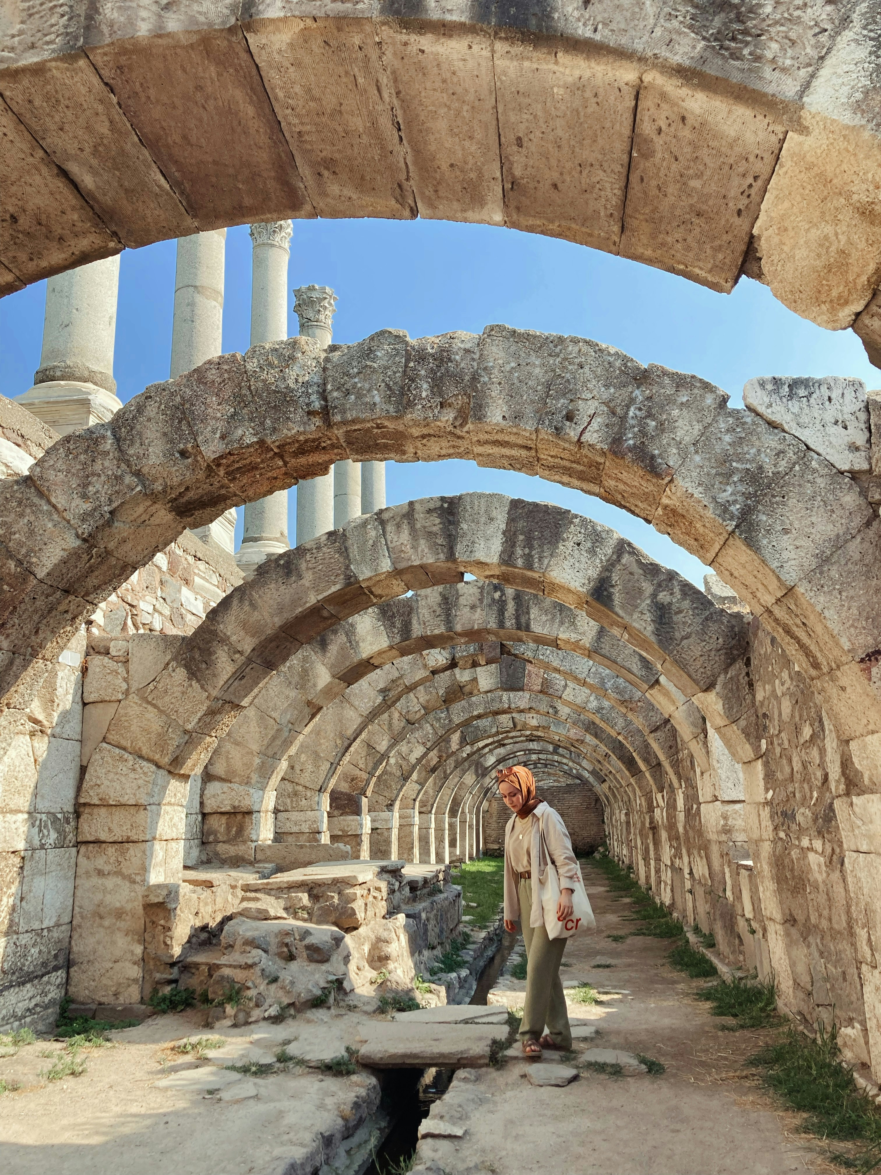 a man is standing in a stone tunnel