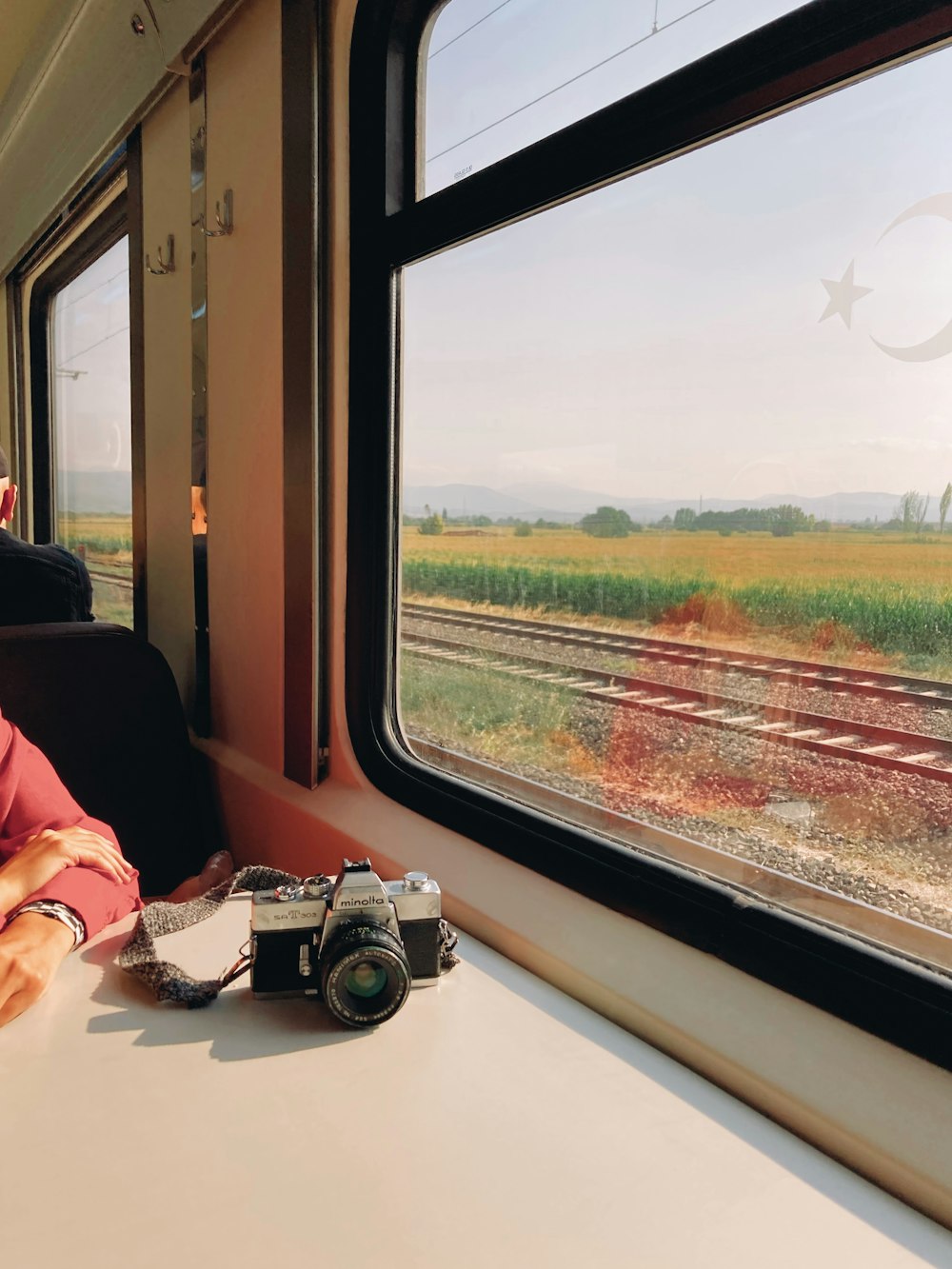 a man sitting on a train looking out the window