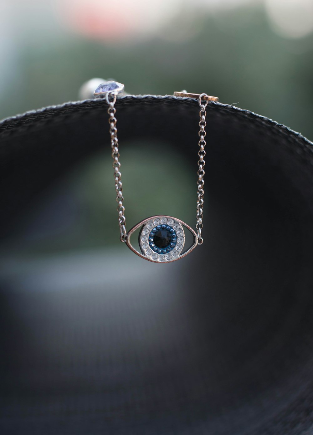 a close up of an evil eye necklace