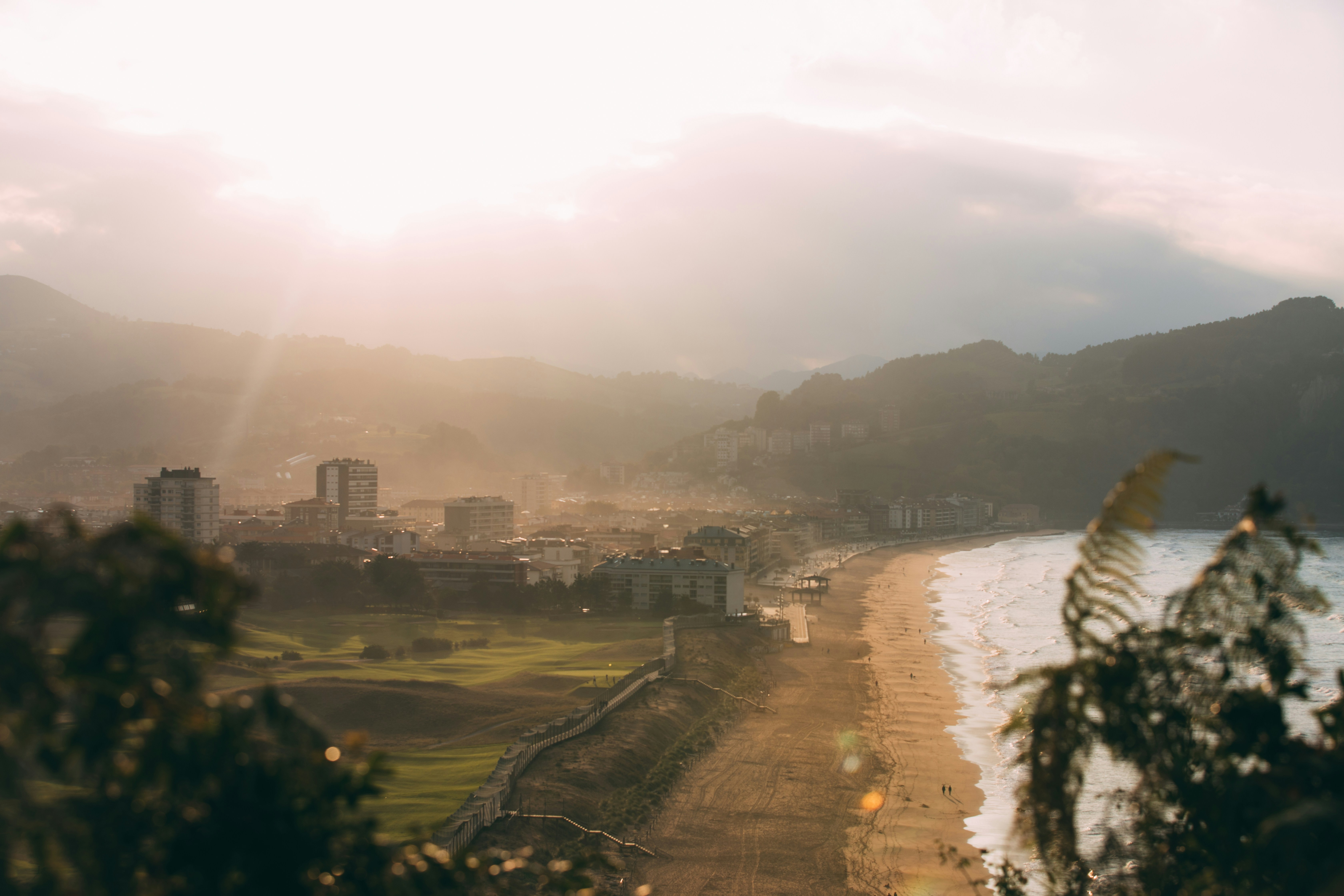 a view of a beach with a city in the background