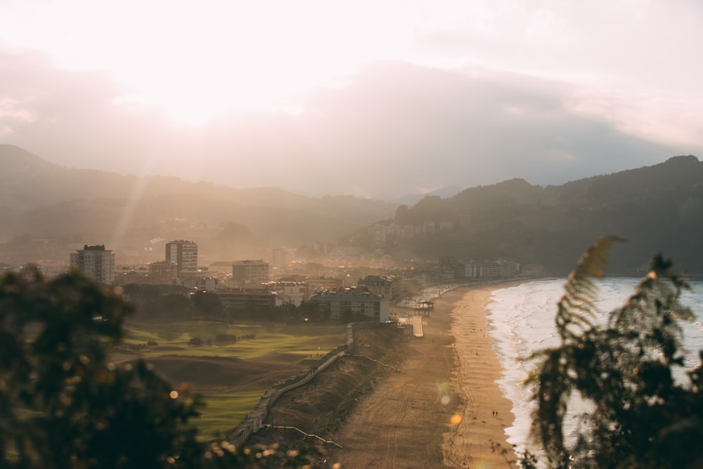 a view of a beach with a city in the background