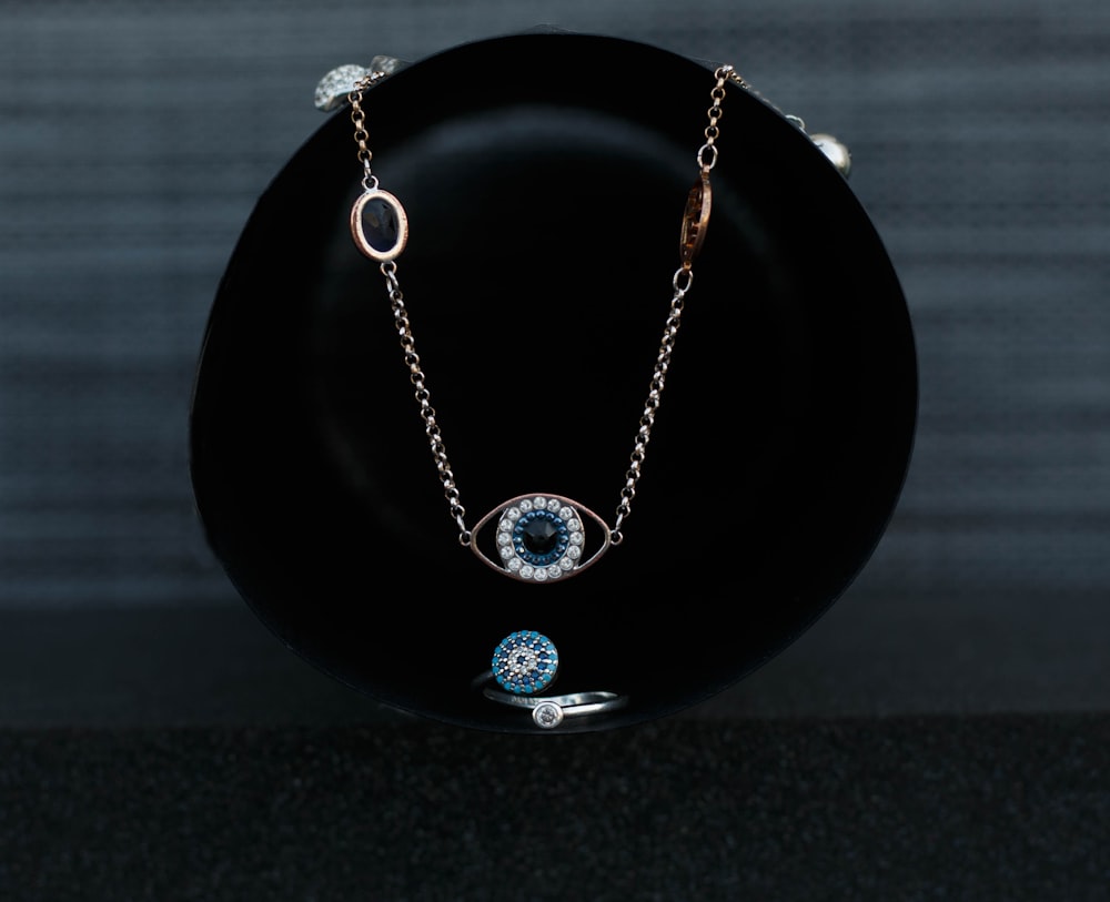 a black plate with a chain and a blue eye on it