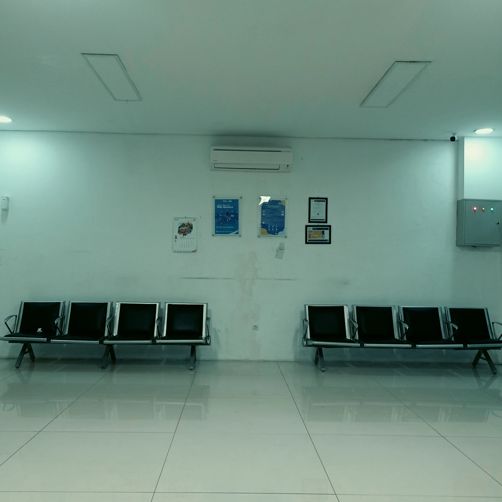 Empty clinic waiting area with rows of vacant chairs