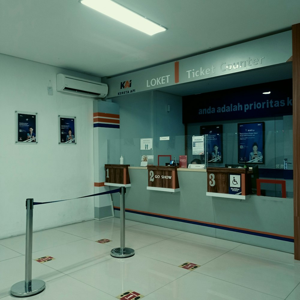 a ticket counter in an airport terminal with a barrier