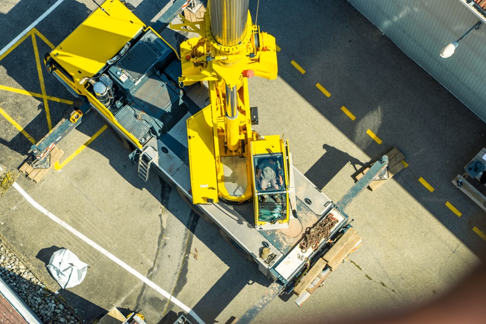 a yellow crane sitting on top of a parking lot