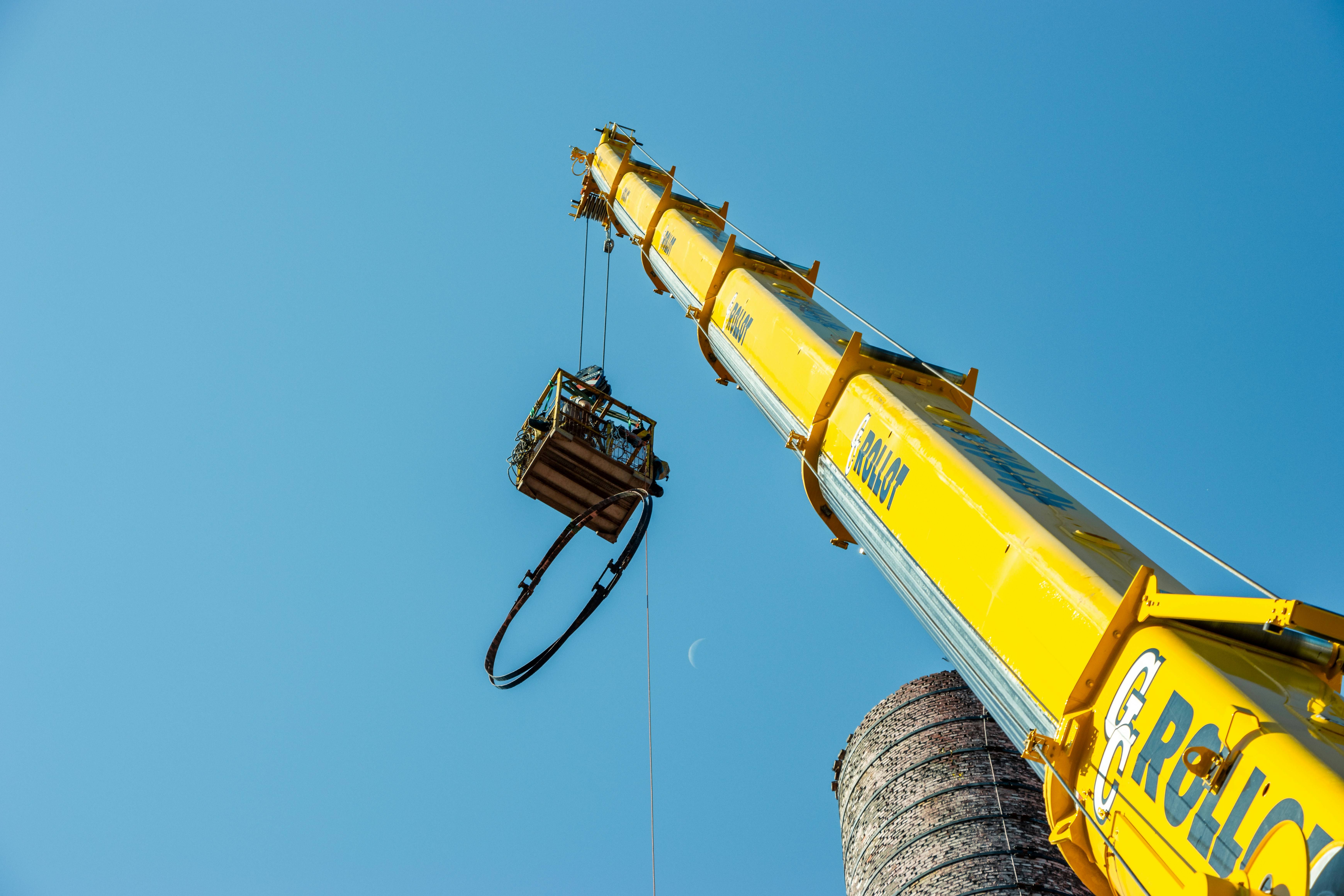 Crane lifting bucket onto truck