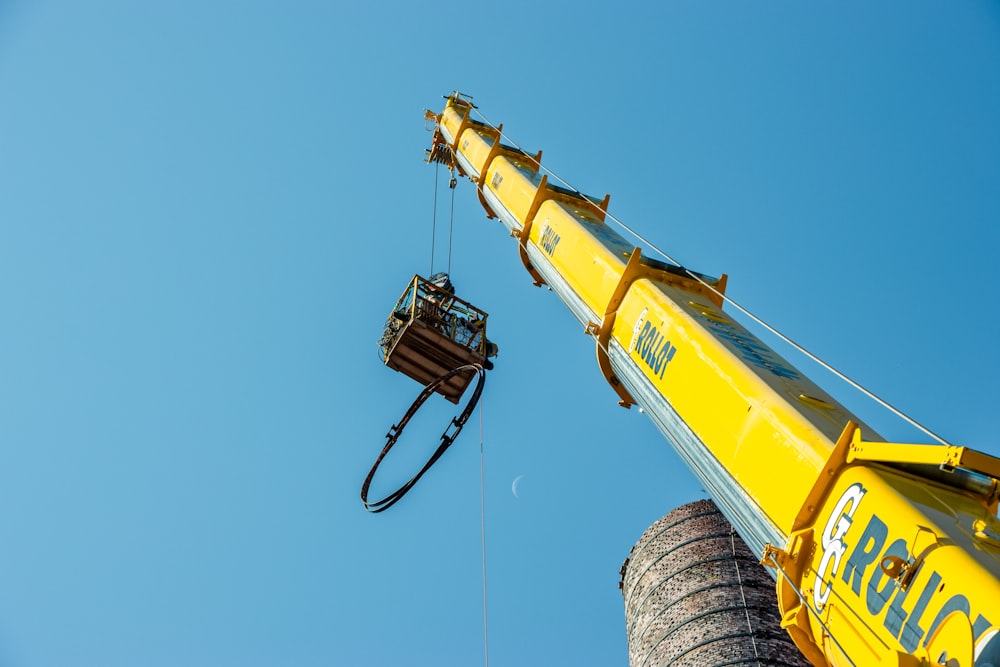 a crane is lifting a bucket onto a truck