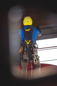 a man wearing a yellow helmet and safety gear