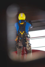 a man wearing a yellow helmet and safety gear