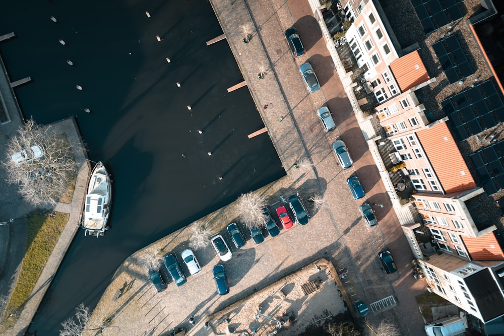 an aerial view of a parking lot with a boat in the water