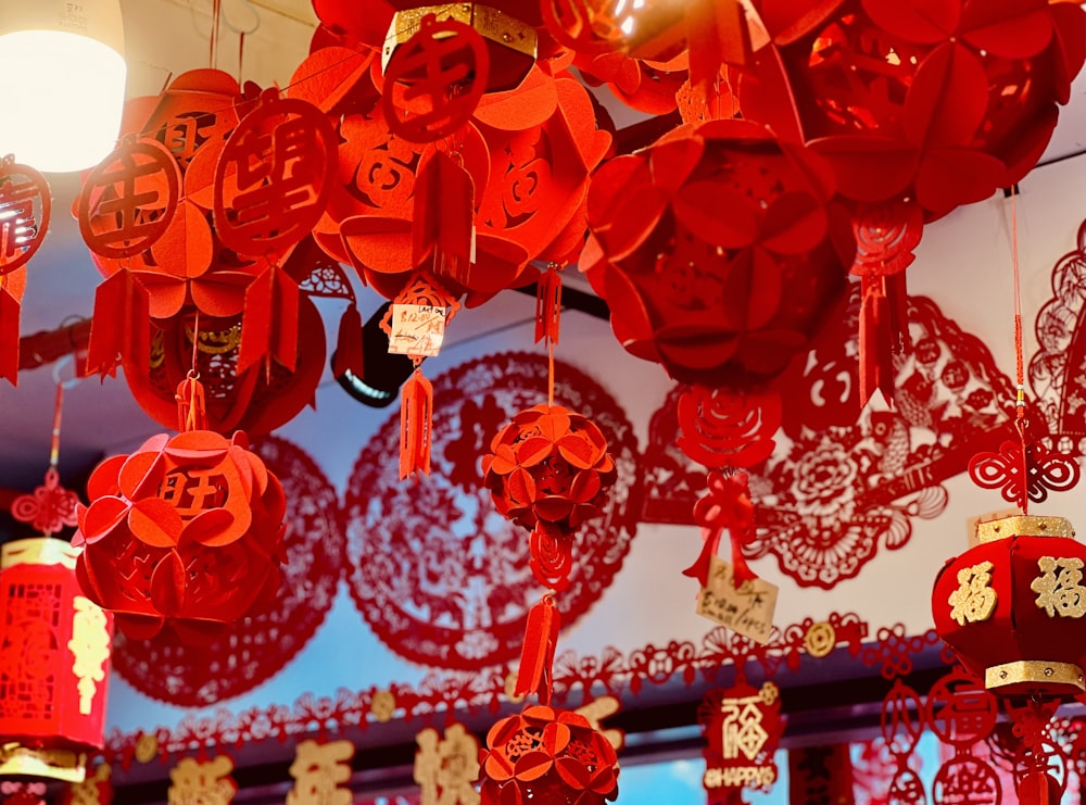 a bunch of red lanterns hanging from a ceiling