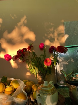 Bright tea leaves and flowers arranged artistically in a sunlit kitchen