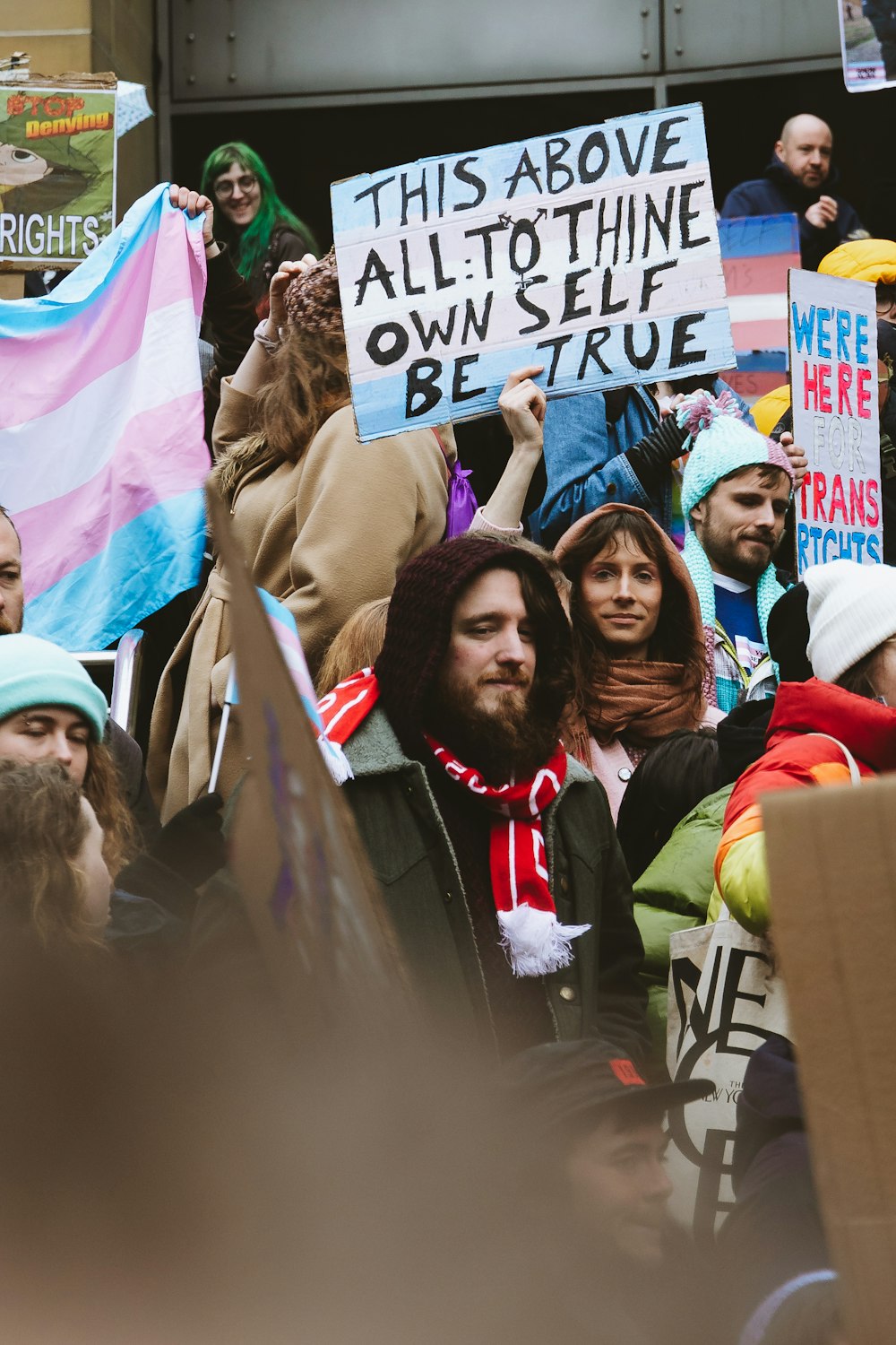 a group of people holding signs in the street