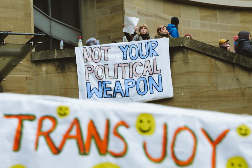 a group of people holding a sign that says not your political weapon