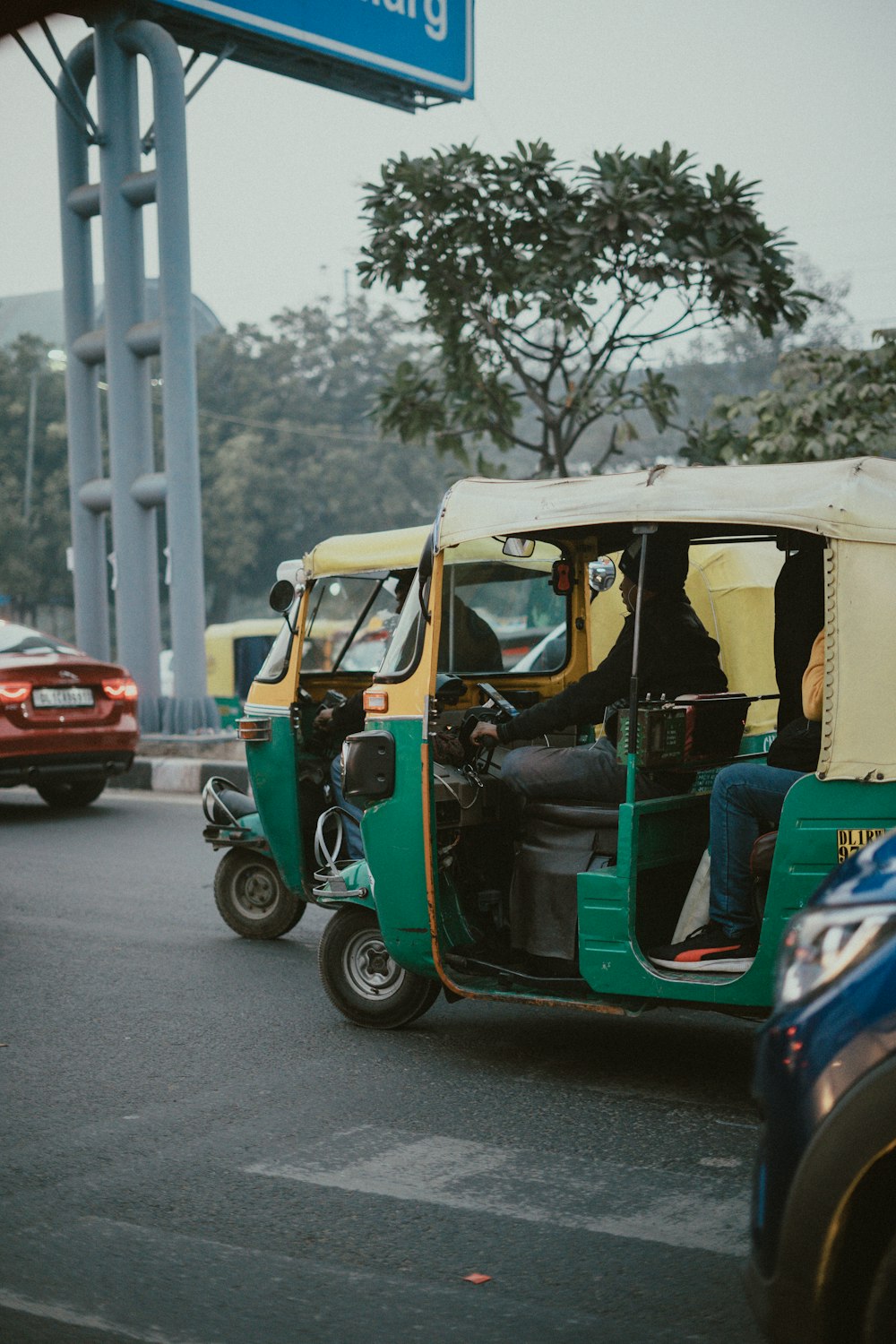 a man driving a three wheeled vehicle down a street