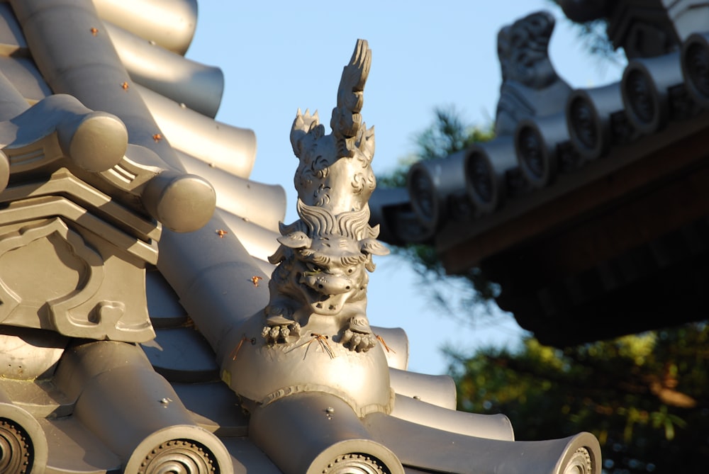 a close up of a dragon statue on a building
