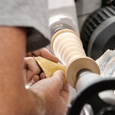 a man is working on a piece of wood