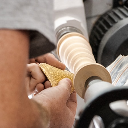 a man is working on a piece of wood
