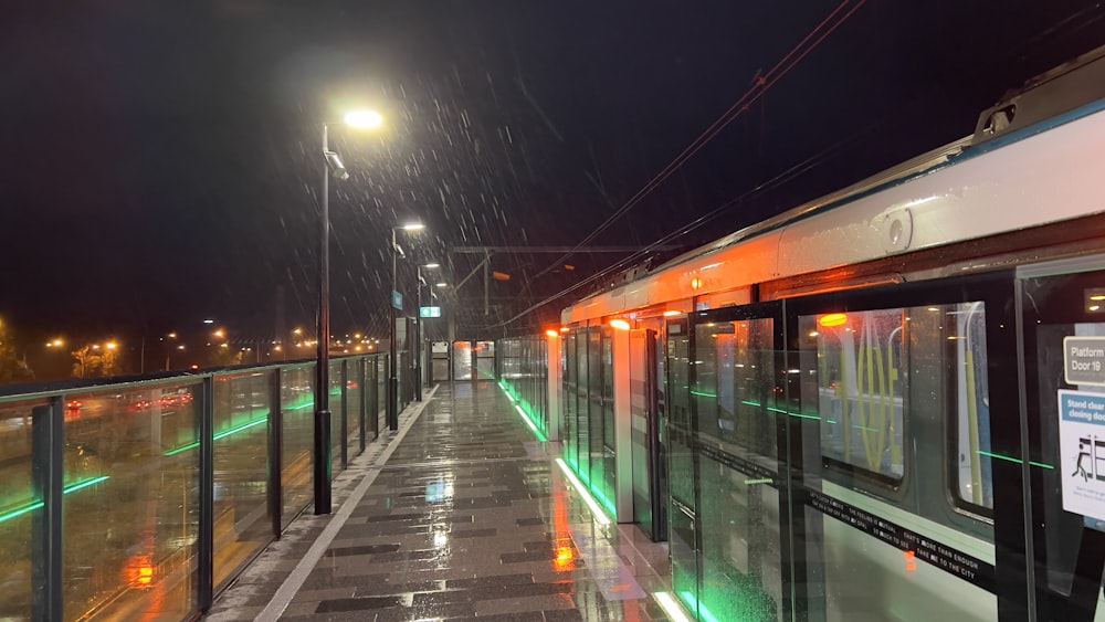 a train station at night with lights on