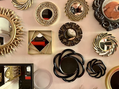 An artistic arrangement of framed mirrors, prints, and photographs showcasing the shop’s diverse framing options.