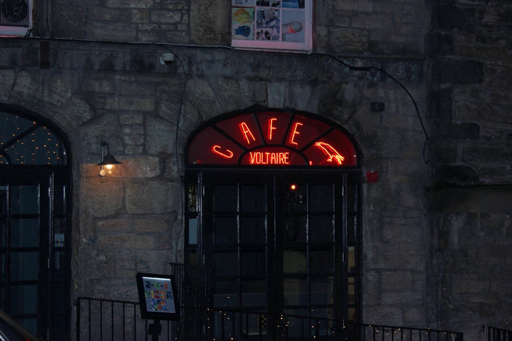 a building with a neon sign on the front of it