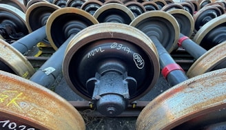 A collection of various aluminium wheels and rims ready for recycling or resale.