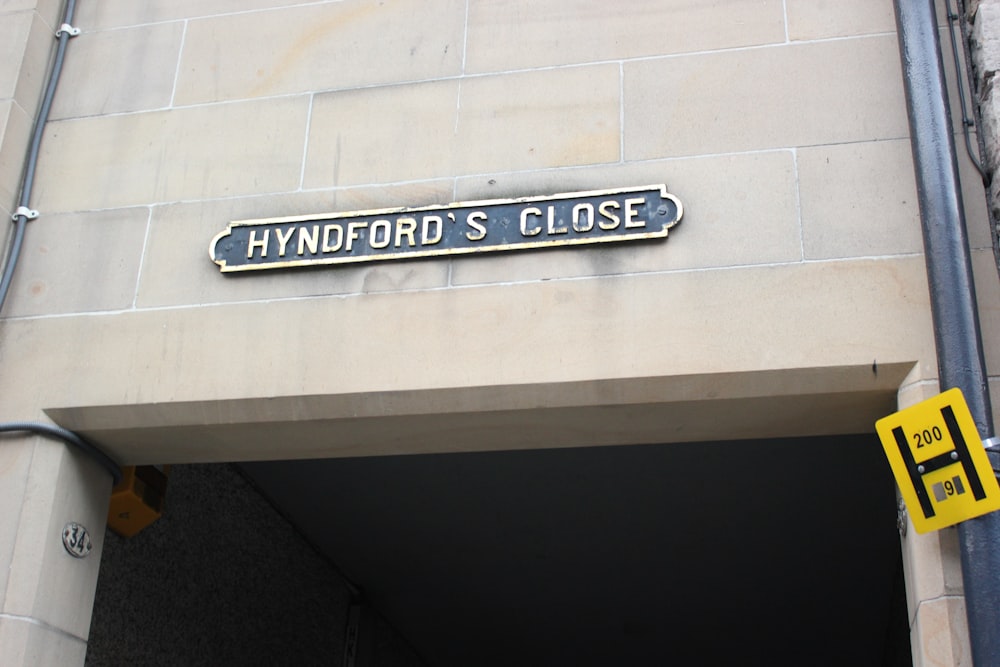 a close up of a street sign on a building