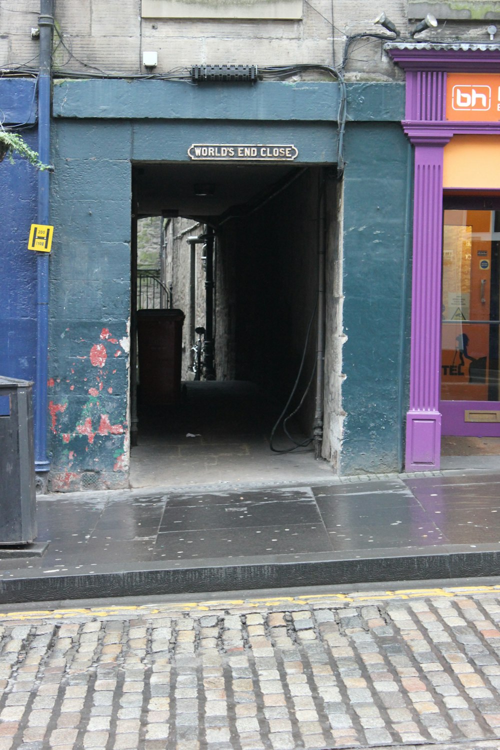 a purple and blue building with a black fire hydrant